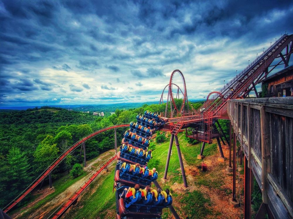 Wildfire roller coaster at Silver Dollar City dropping through green Ozark hills